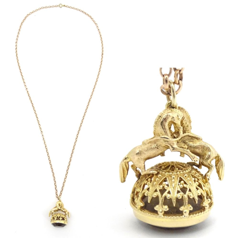 A 9ct gold pendant fob seal surmounted by a pair of prancing horses / ponies and set with facet cut (1 of 9)