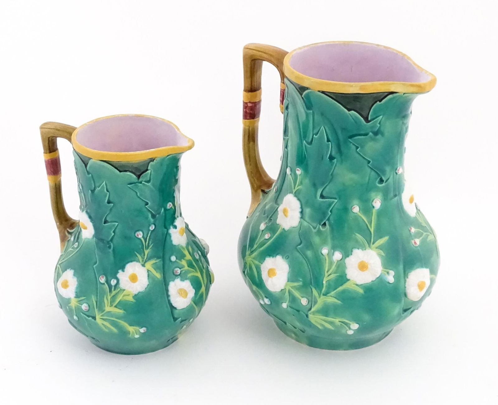 Two majolica jugs with flowers and foliate decoration. One marked 'Minton' under. Largest approx. 8 (1 of 14)