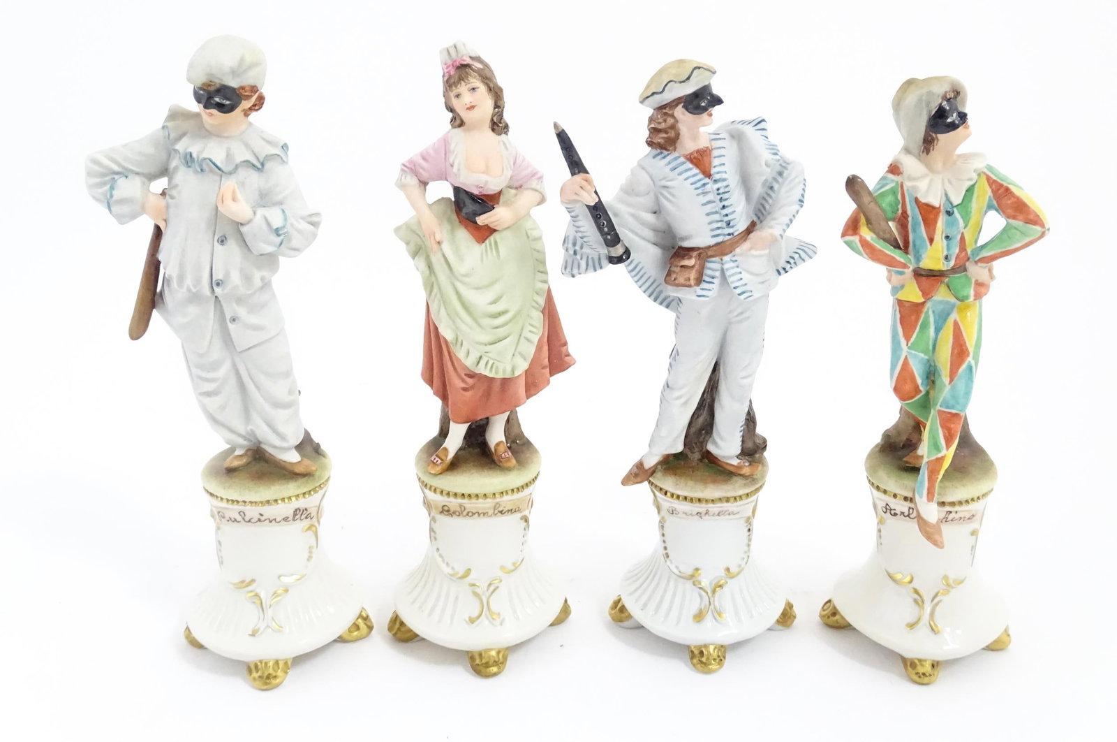 Four Capodimonte Harlequin / masquerade figures designed by Merli comprising Colombina, Pulcinella,: Four Capodimonte Harlequin / masquerade figures designed by Merli comprising Colombina, Pulcinella, Brighella and Arlecchino. Approx. 8" high (4) Please Note - we do not make reference to the conditio