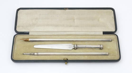 A cased silver writing / correspondence set comprising pen, pencil and paper knife with seal end,: A cased silver writing / correspondence set comprising pen, pencil and paper knife with seal end, hallmarked London 1920, maker John Henry Hill. Case approx. 8 1/2" wide Please Note - we do not make r