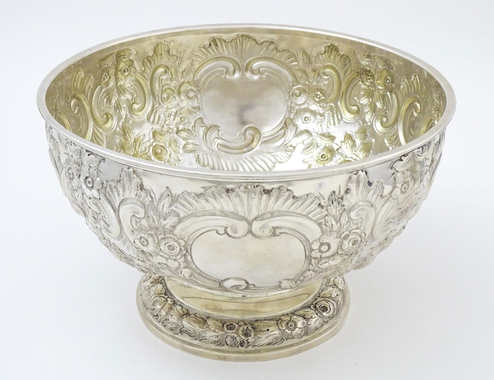 A silver pedestal punch bowl with embossed floral and C scroll detail, hallmarked London 1903, maker: A silver pedestal punch bowl with embossed floral and C scroll detail, hallmarked London 1903, maker Charles Stuart Harris. Approx. 8 3/4" diameter x 5 1/2" high Please Note - we do not make reference