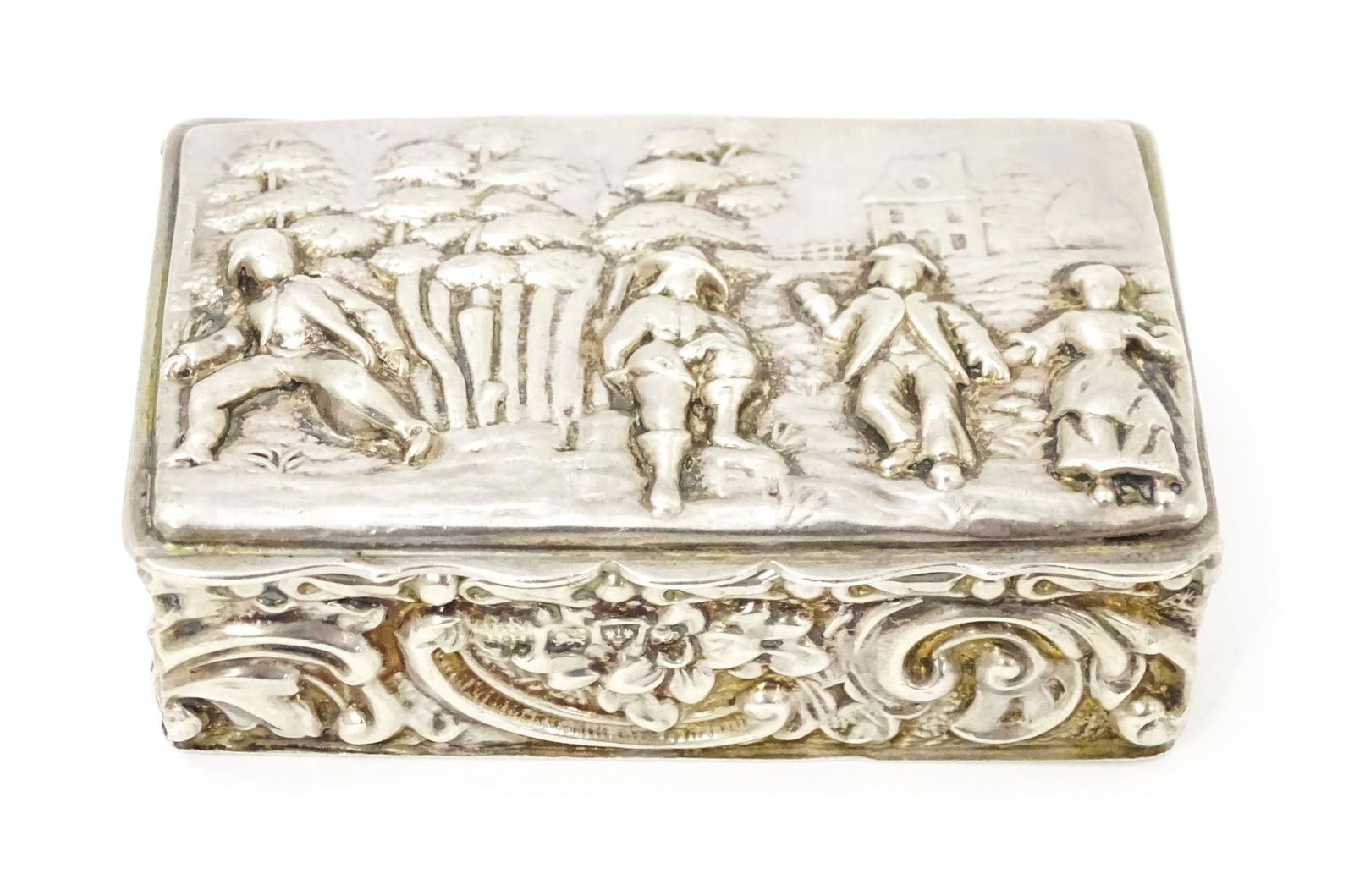 A silver snuff box with embossed decoration depicting figures in a landscape, and gilded interior, (1 of 8)