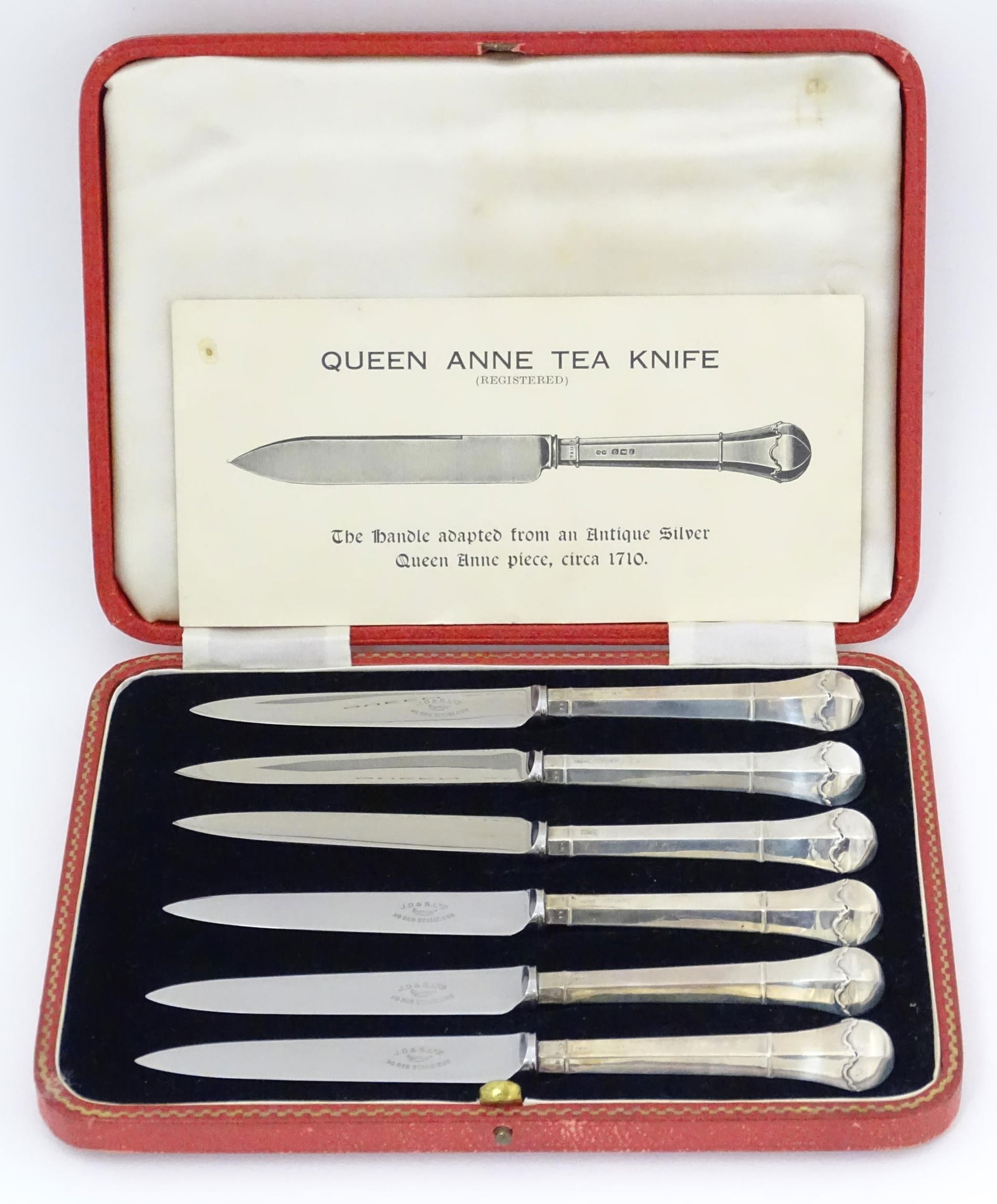 A cased set of six silver handled tea knives titled The Queen Anne Tea Knife (The handle adapted: A cased set of six silver handled tea knives titled The Queen Anne Tea Knife (The handle adapted from an Antique Silver Queen Anne piece'), hallmarked Sheffield 1936, maker James Dixon & Sons Ltd. App