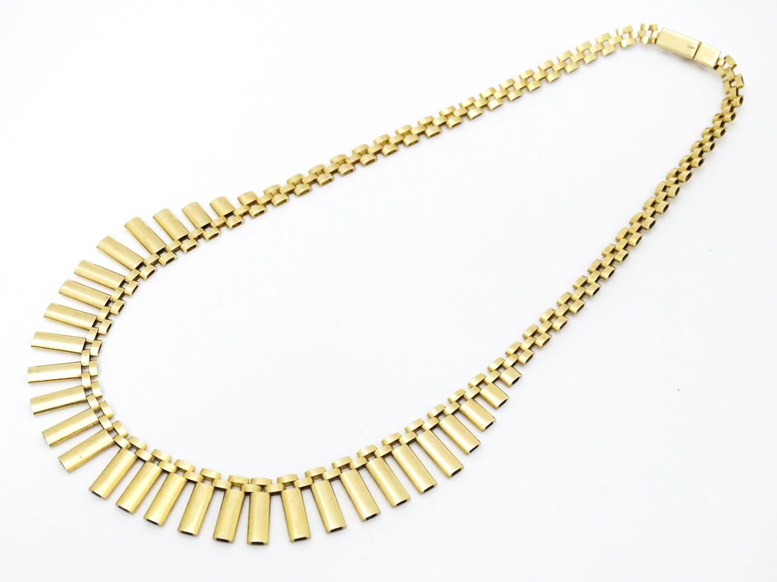 A 9ct gold necklace formed as a Cleopatra collar. Approx 16" long Please Note - we do not make: A 9ct gold necklace formed as a Cleopatra collar. Approx 16" long Please Note - we do not make reference to the condition of lots within descriptions. We are however happy to provide additional inform