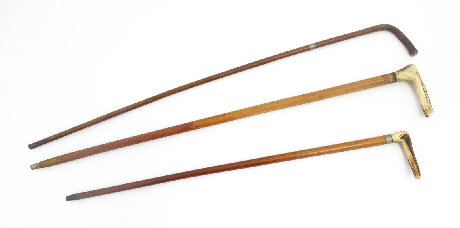 Three walking sticks / canes, one leather covered example and two with antler handles, one with (1 of 12)