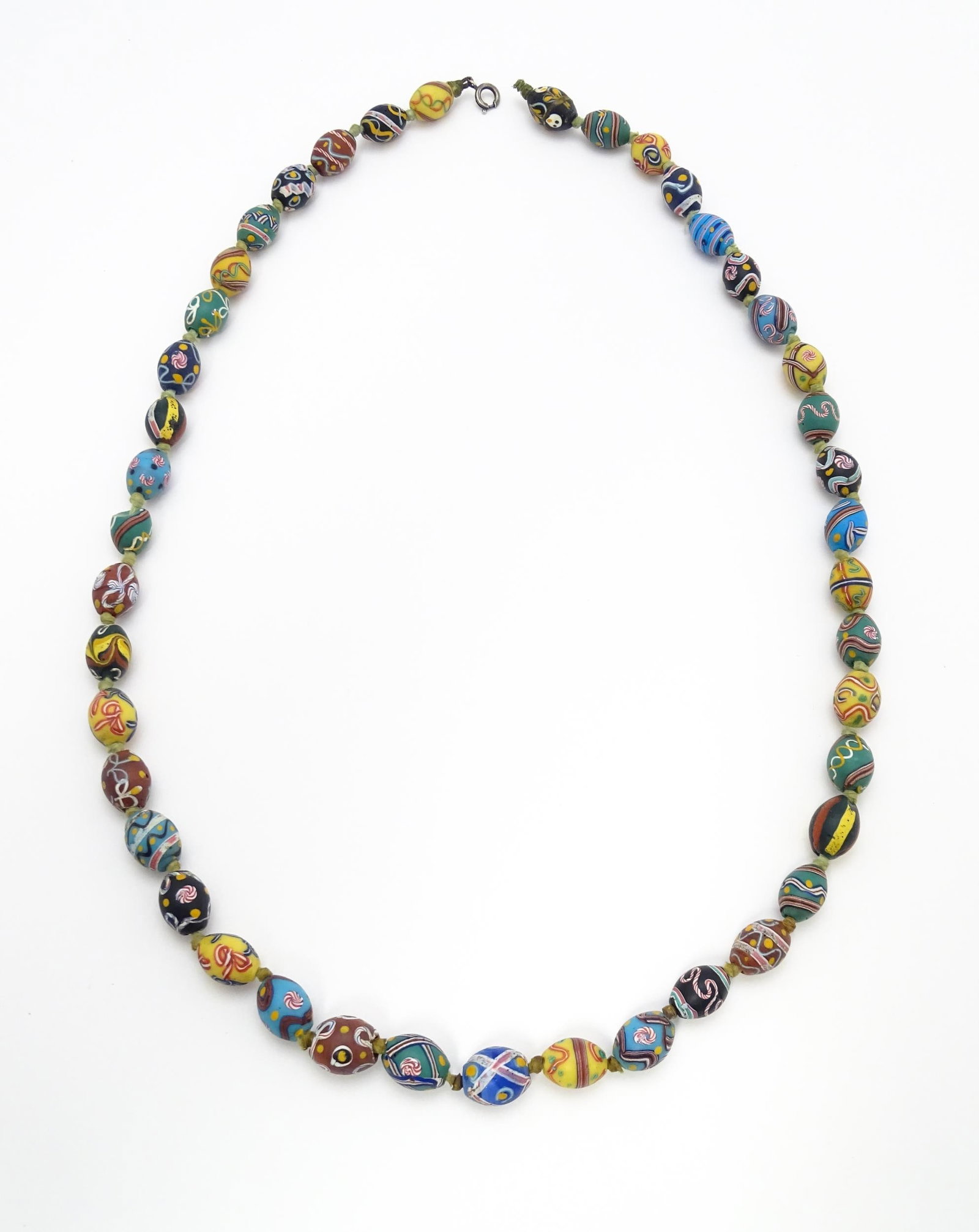 A necklace comprising approximately 42 Venetian glass trade beads of varying designs. Approx. 33" (1 of 4)