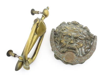 Two 20thC cast brass door knockers, one of Green Man style mask form. Largest approx. 8 1/2" long: Two 20thC cast brass door knockers, one of Green Man style mask form. Largest approx. 8 1/2" long (2)Please Note - we do not make reference to the condition of lots within descriptions. We are however