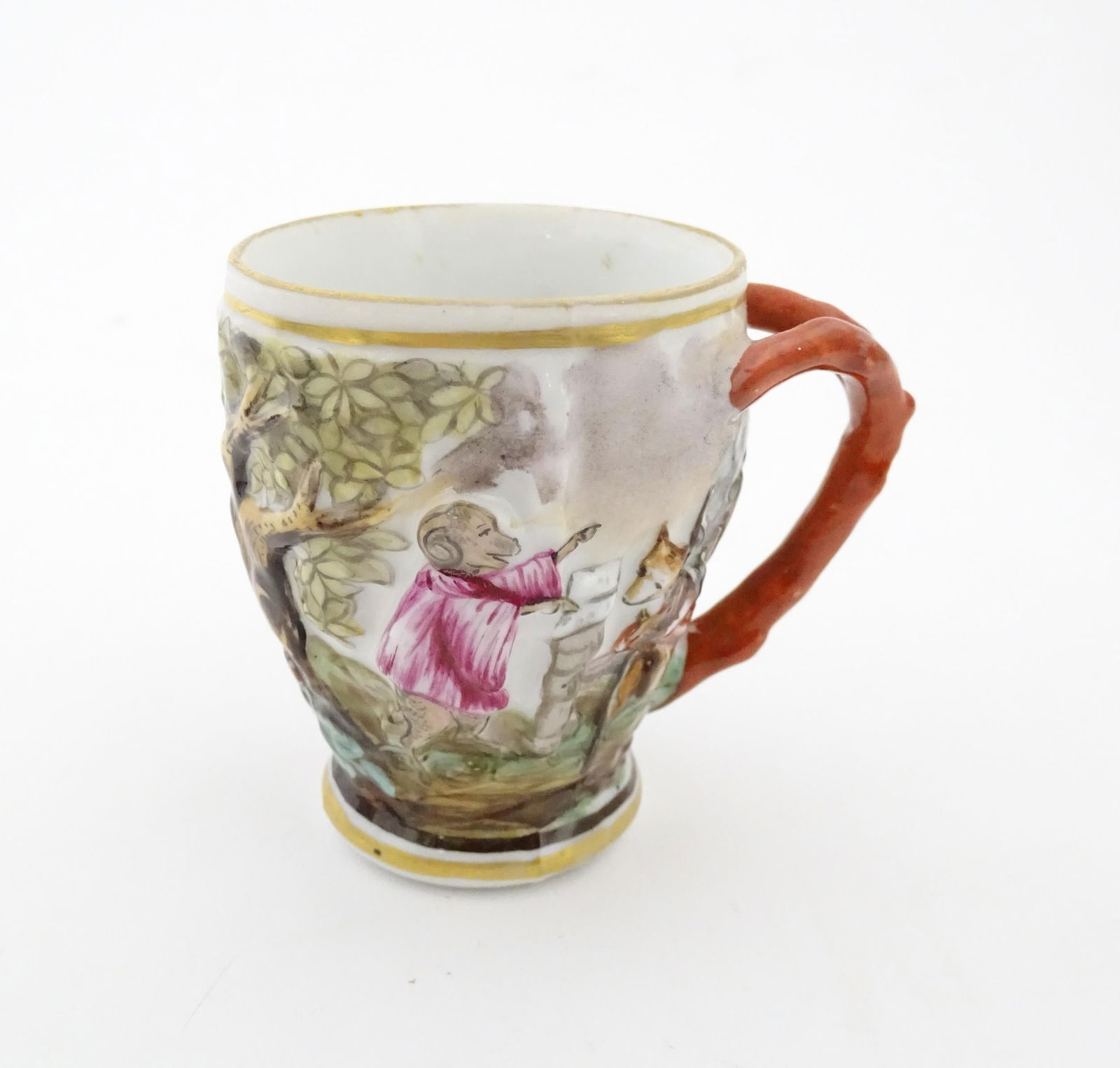 A Continental coffee cup decorated in relief with animals in a landscape. Marked under with: A Continental coffee cup decorated in relief with animals in a landscape. Marked under with Capodimonte style mark. Approx. 2 3/4" high Please Note - we do not make reference to the condition of lots