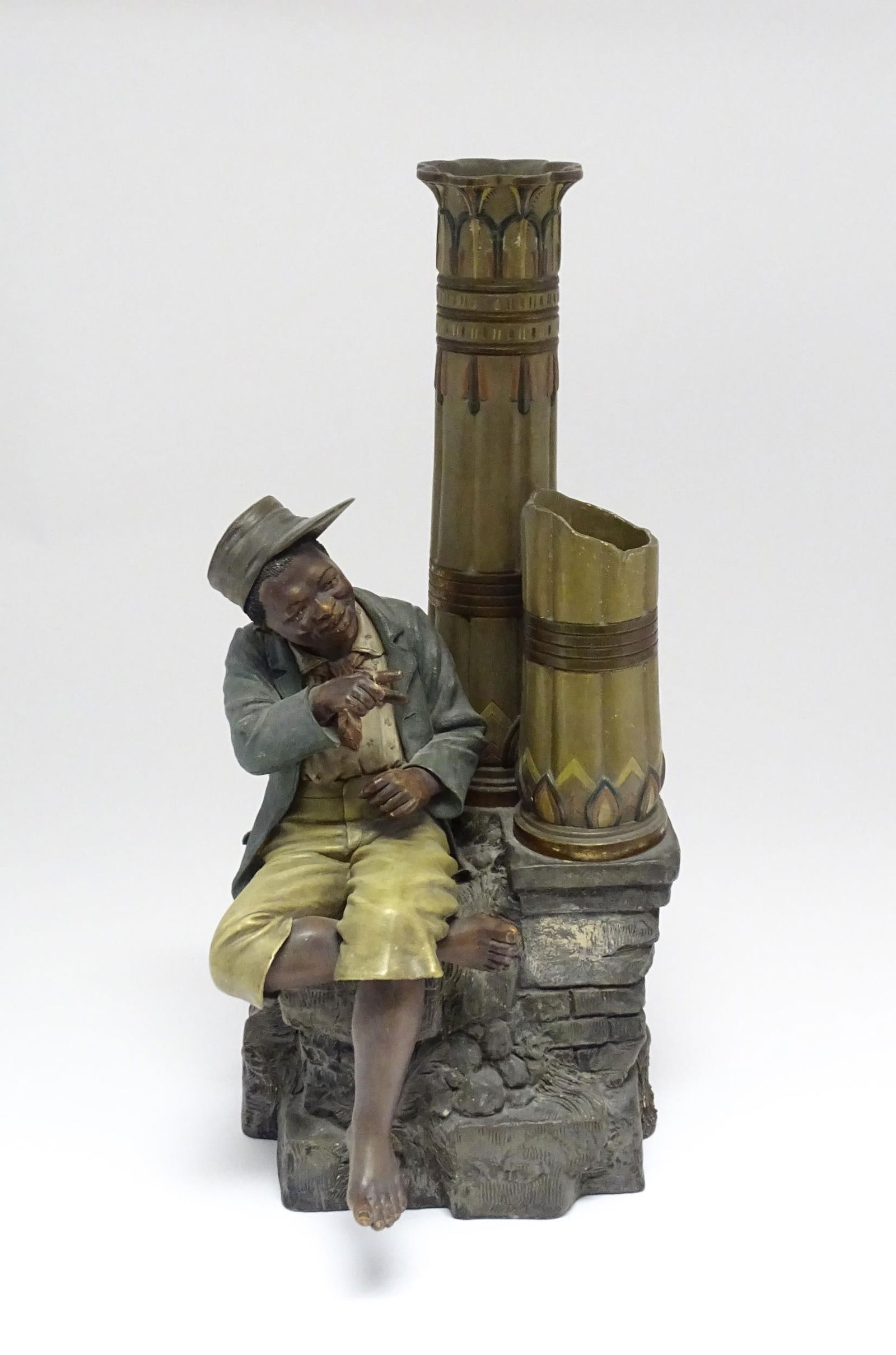 A late 19thC terracotta figure of a boy with decorative columns, having polychrome decoration, by (1 of 11)