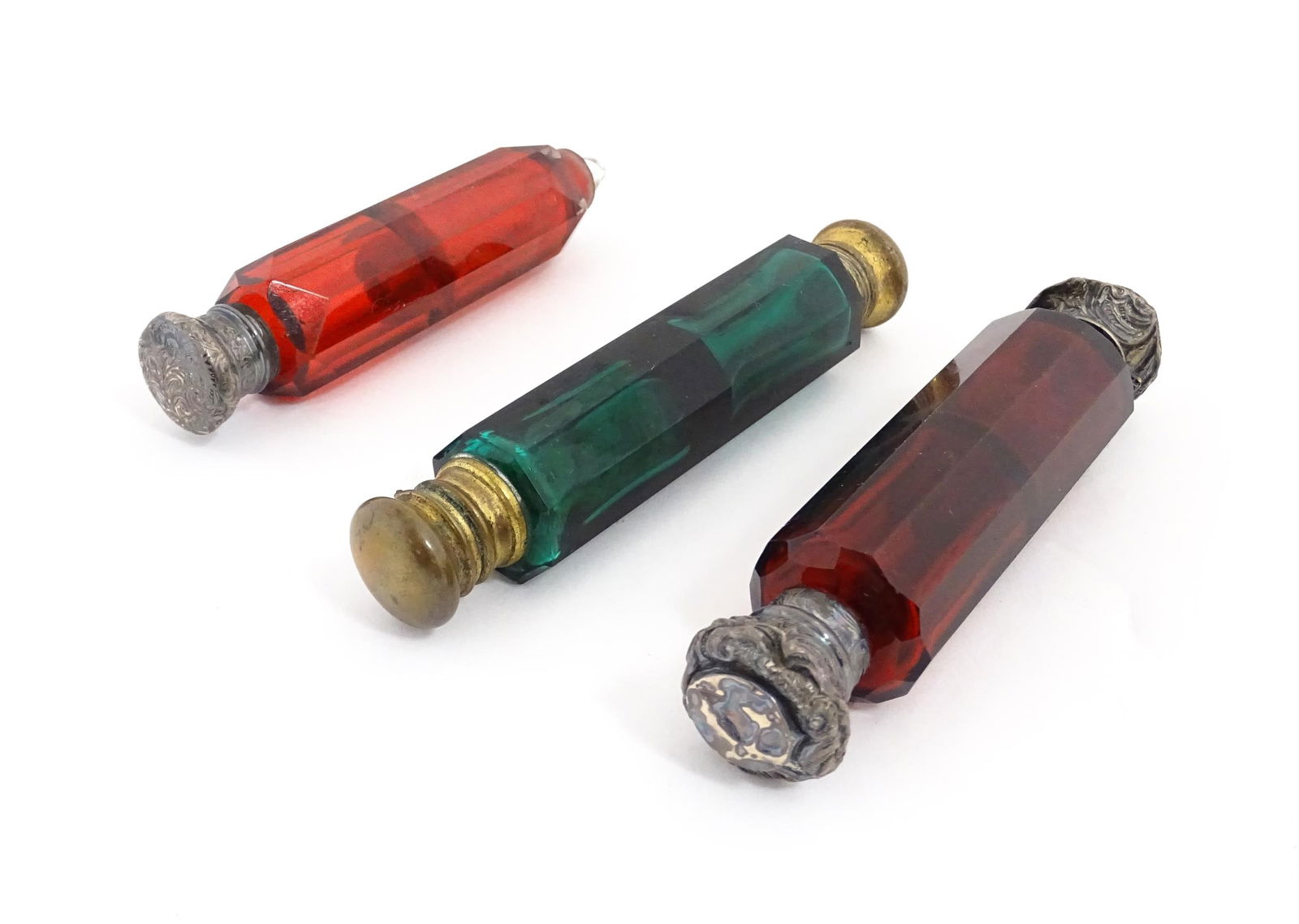 Three various Victorian double ended scent flasks compromising two ruby glass and a green glass: Three various Victorian double ended scent flasks compromising two ruby glass and a green glass example . Largest approx. 5 1/4" (3) Please Note - we do not make reference to the condition of lots wit