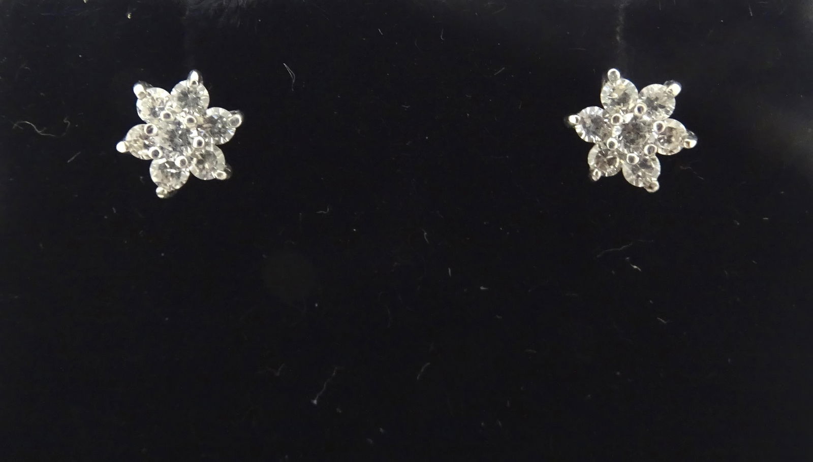 A pair of 9ct gold stud earrings set with diamond clusters. Approx. 1/4" wide  Please Note - we do (1 of 9)