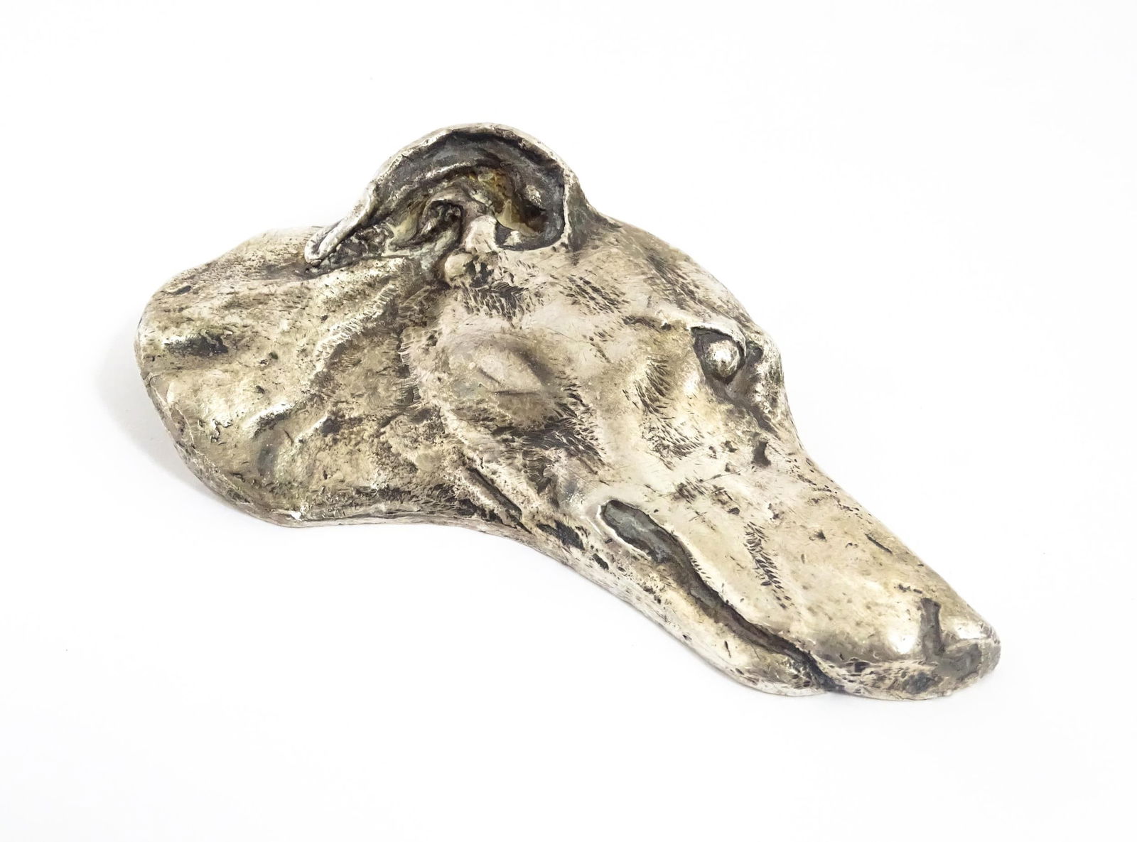 A 20thC cast paperweight modelled as a the head of a Greyhound / Whippet dog. Approx. 4" long (1 of 7)