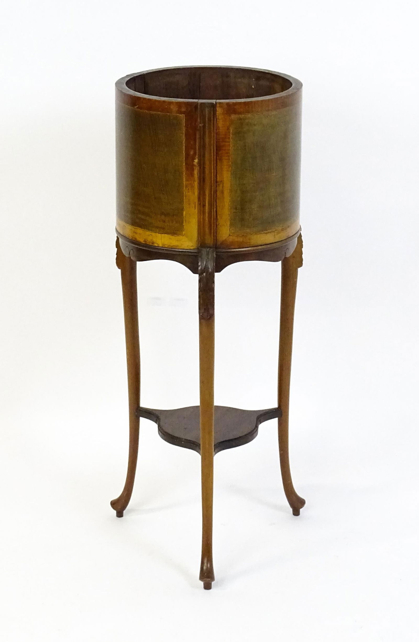 An early 20thC mahogany jardinière with a barrel top raised on three carved cabriole legs (1 of 5)