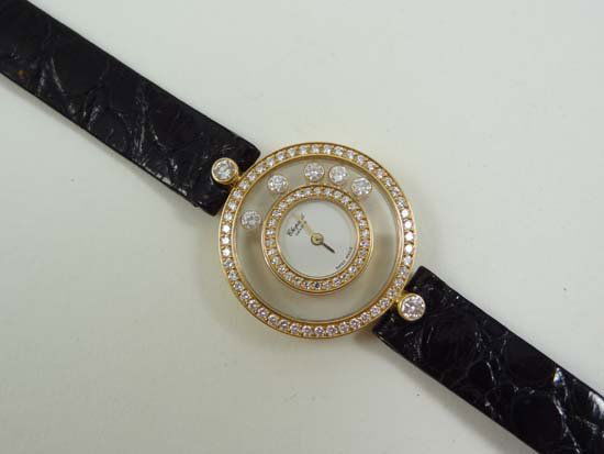 Ladies Watch ; CHOPARD. A fine 18ct white gold and: Ladies Watch ; CHOPARD. A fine 18ct white gold and diamond set lady's quartz wristwatch ' Happy Diamonds ' , Case No.656644-4097 , purchase receipt shows 12/12/01, jewelled quartz movement, white dial