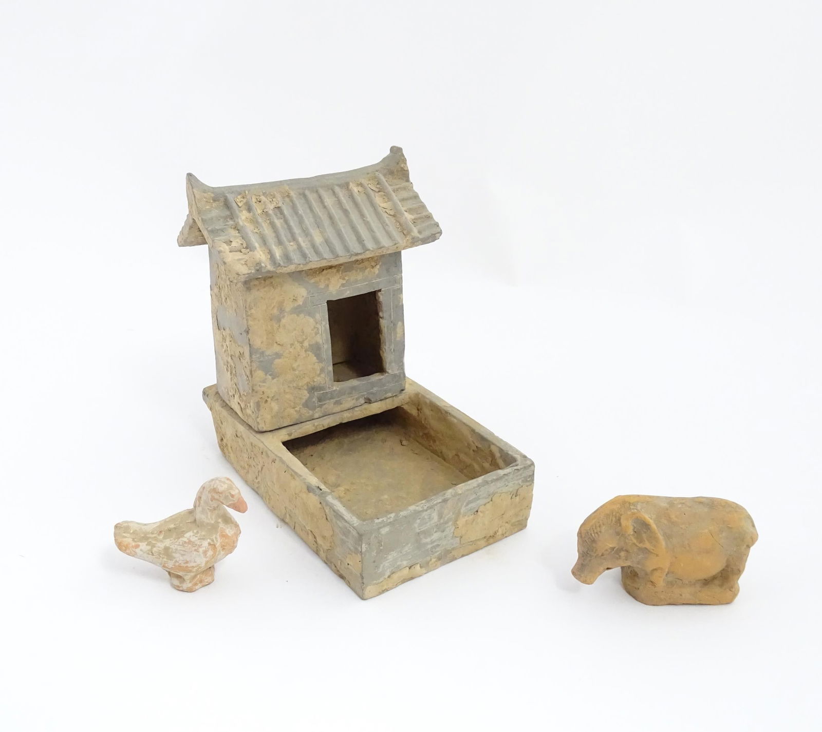 A Chinese Han dynasty pottery model of a pig sty with hut, a model of a boar and a model of a duck. (1 of 20)