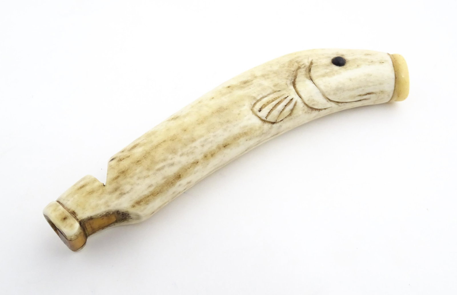 A 19thC novelty carved antler whistle of fish form. Approx. 5 1/4" long Please Note - we do not: A 19thC novelty carved antler whistle of fish form. Approx. 5 1/4" long Please Note - we do not make reference to the condition of lots within descriptions. We are however happy to provide additional 