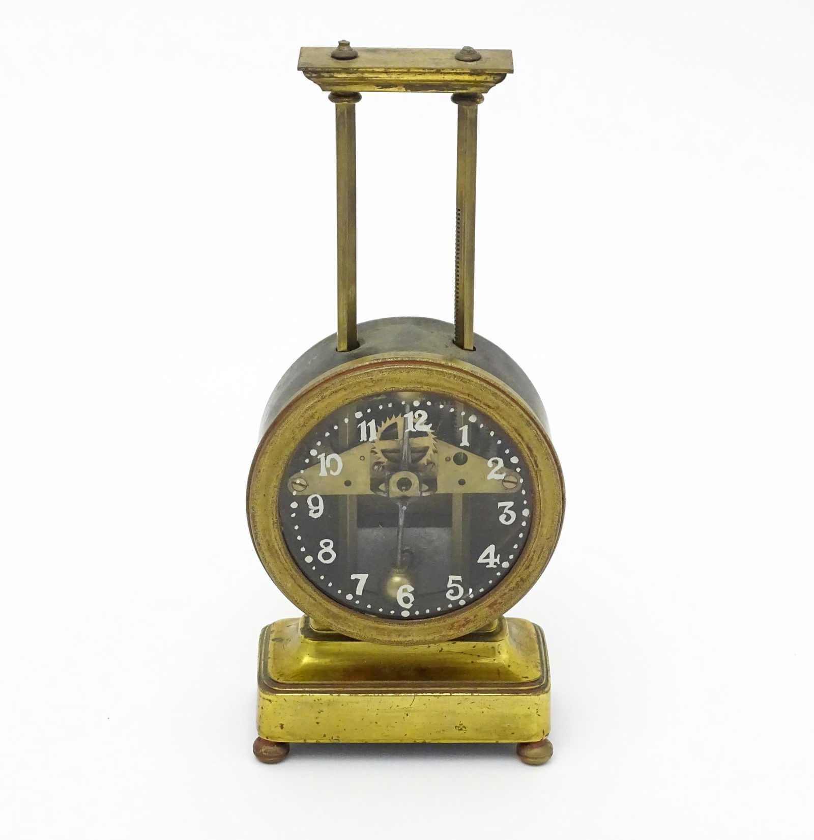 A gilt brass cased gravity clock, the dial with Arabic numerals. Approx. 9 1/2" high  Please Note - (1 of 7)