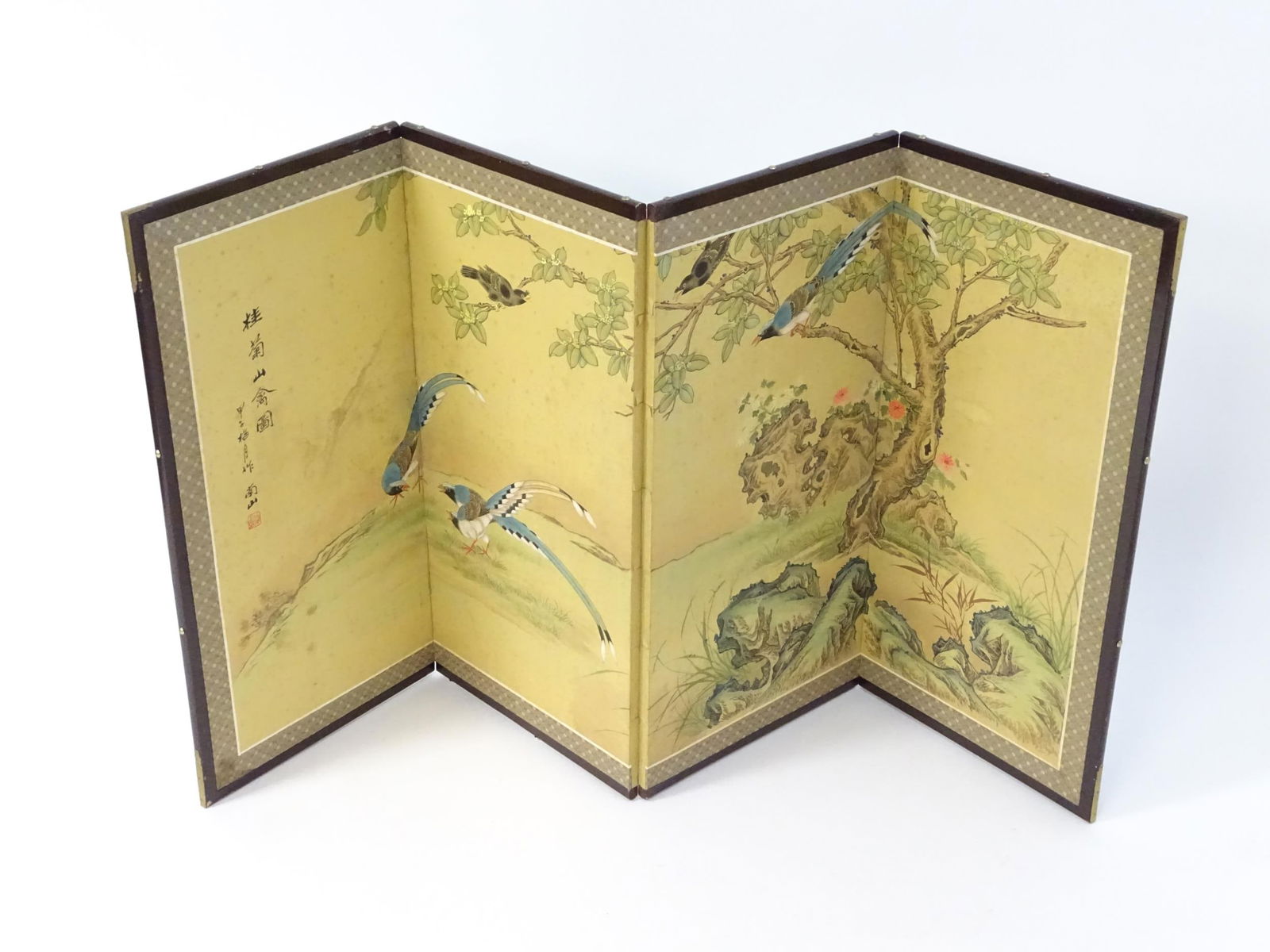 A mid 20thC Oriental folding screen, the four sections decorated with red-billed blue magpies, (1 of 5)