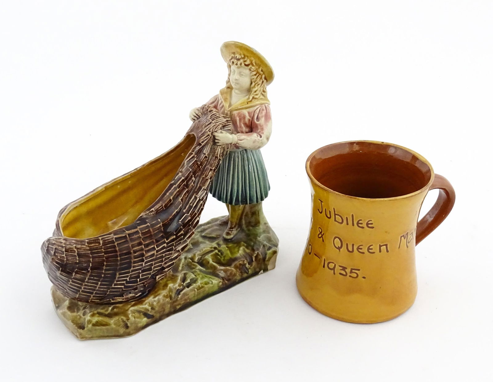 A Victorian Torquay majolica pottery table salt modelled as a fisher girl with a net. Marked under (1 of 20)