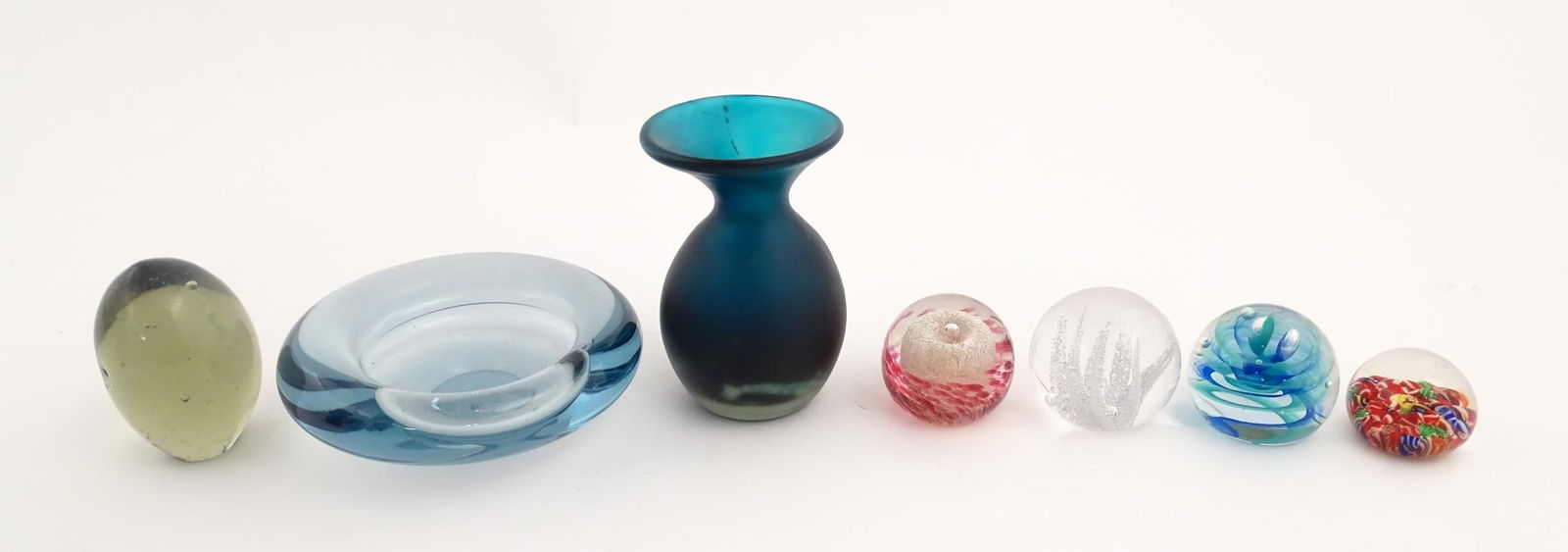 A quantity of glassware to include a Mdina glass vase, a Holmegaard ashtray, and assorted: A quantity of glassware to include a Mdina glass vase, a Holmegaard ashtray, and assorted paperweights to include examples by Caithness, Kosta Boda etc. Mdina vase approx. 4 1/4" high (7)Please Note -