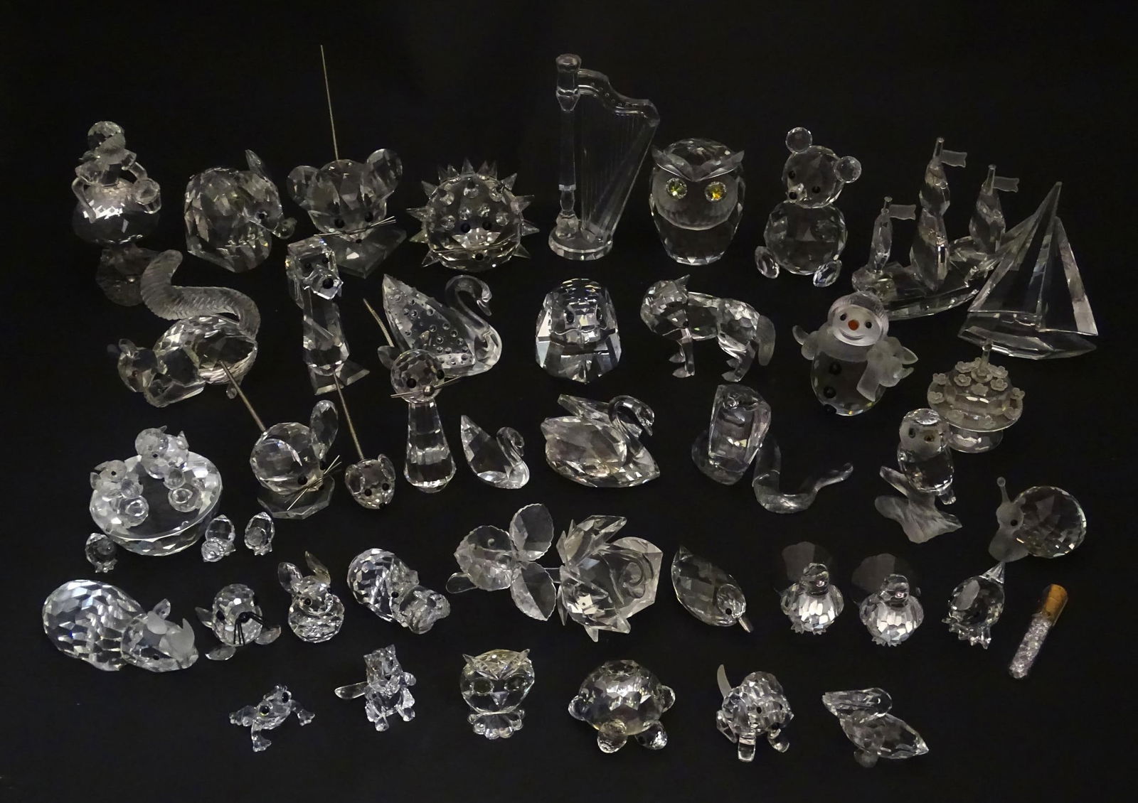 A quantity of assorted Swarovski crystal ornaments to include rhino, swans, hedgehog, snail, (1 of 20)