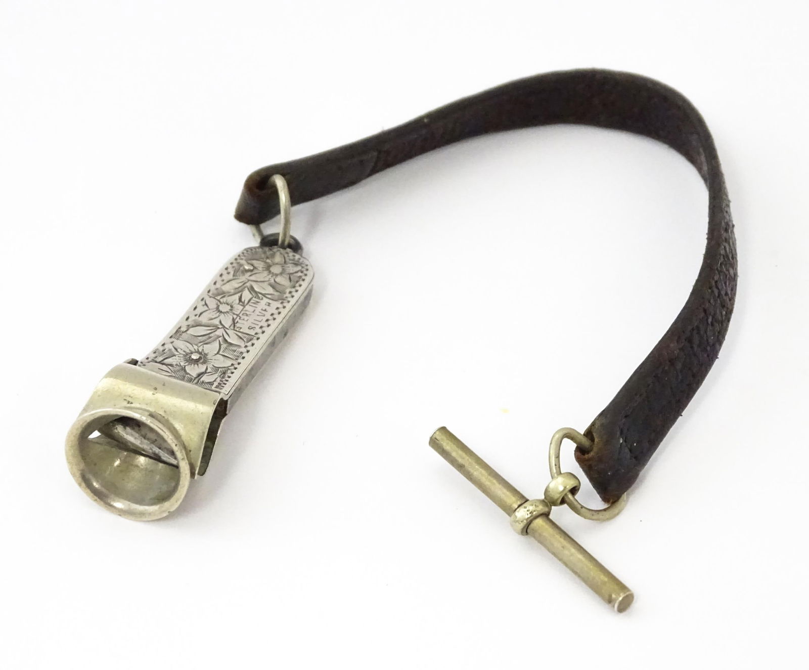 A sterling silver cigar cutter with engraved floral decoration. Approx. 2" wide (1 of 6)