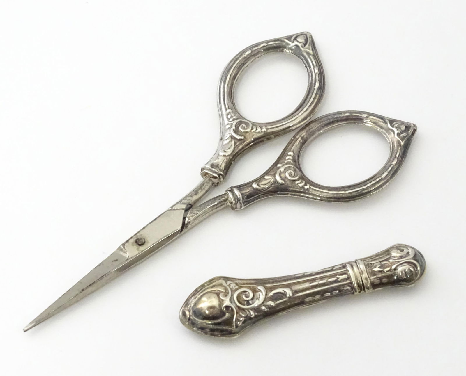 A silver needle case maker Ari D Norman, together with silver handled scissors. Scissors approx. 4: A silver needle case maker Ari D Norman, together with silver handled scissors. Scissors approx. 4 1/4" long (2)Please Note - we do not make reference to the condition of lots within descriptions. We