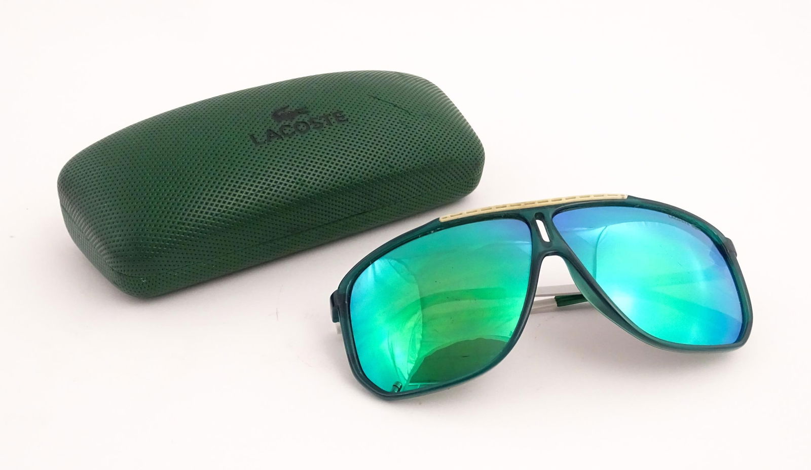 Vintage fashion / clothing: A pair of Lacoste L652S sunglasses in green with original case. Approx.: Vintage fashion / clothing: A pair of Lacoste L652S sunglasses in green with original case. Approx. 5 1/2" wide.Please Note - we do not make reference to the condition of lots within descriptions. We