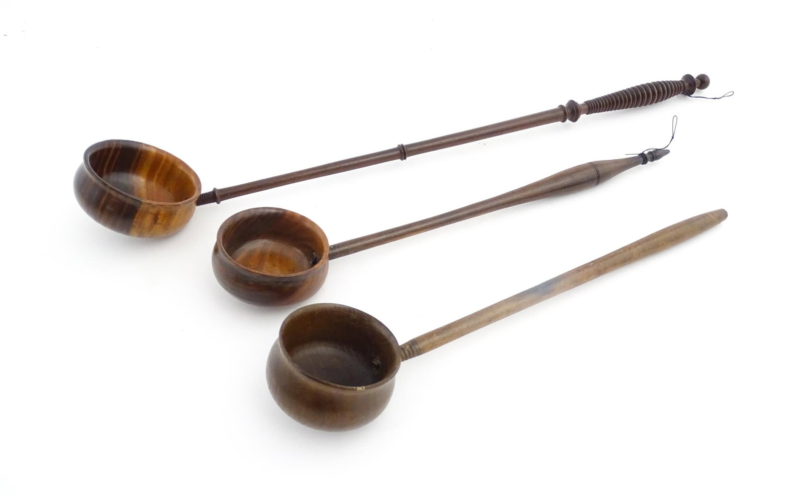 Treen : Three 18th / 19thC wooden cordial spoons. Largest approx. 17 1/2" long (3): Treen : Three 18th / 19thC wooden cordial spoons. Largest approx. 17 1/2" long (3)Please Note - we do not make reference to the condition of lots within descriptions. We are however happy to provide a
