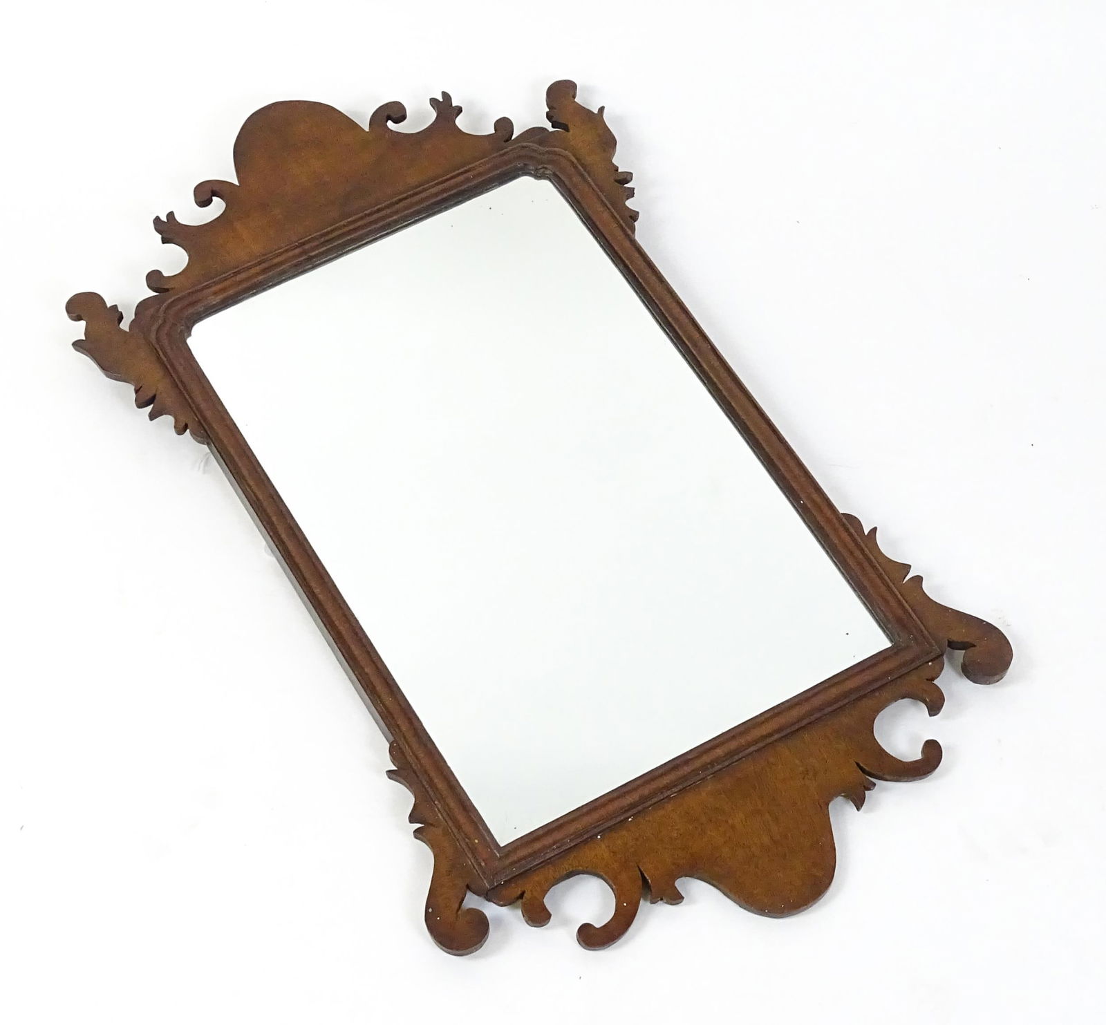 A late 19thC / early 20thC mahogany wall mirror with scrolled detailing and a moulded surround. 16" (1 of 5)