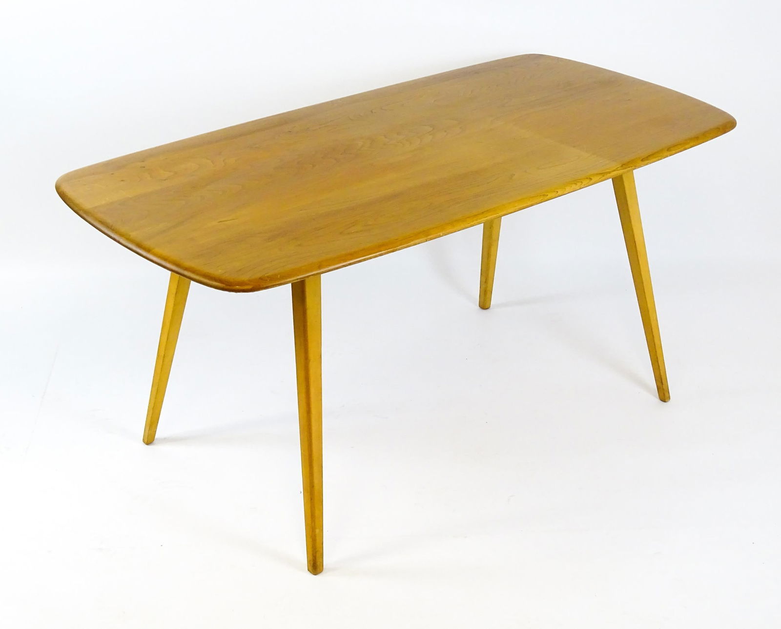 Vintage / Retro: An elm Ercol dining table raised on four tapering legs. 60" wide x 30" deep x 29": Vintage / Retro: An elm Ercol dining table raised on four tapering legs. 60" wide x 30" deep x 29" high.Please Note - we do not make reference to the condition of lots within descriptions. We are howe