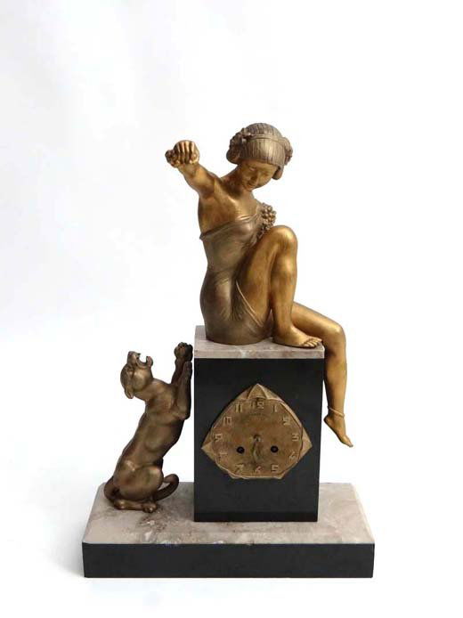Art Deco: Superb Mantle clock circa 1930. Two colo: Art Deco: Superb Mantle clock circa 1930. Two colour Marble base surmounted by a gilded figure of a scantily clad young woman playing with her dog with a quality 8 day drum movement with makers name "