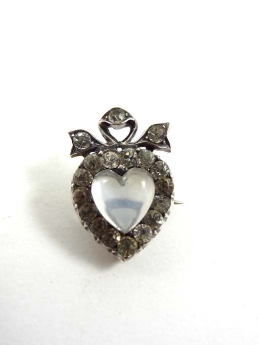 A .800 silver brooch formed as a heart with heart : A .800 silver brooch formed as a heart with heart shaped moonstone to centre bordered by white stones 1" high