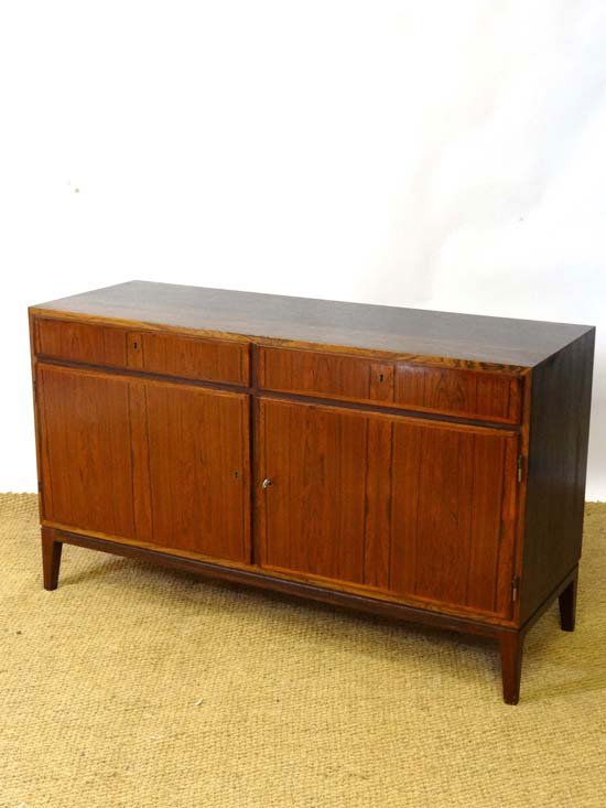 Vintage Retro : a Danish Rosewood low cabinet / sid: Vintage Retro : a Danish Rosewood low cabinet / sideboard designed by Omann Jun with two drawers and two cupboard doors standing on square tapering slightly splayed legs 47 1/4" wide and 27 3/4" high