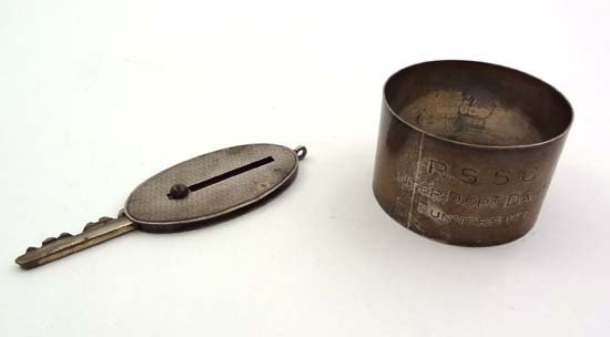 A HM silver napkin ring Birmingham 1917 maker E J : A HM silver napkin ring Birmingham 1917 maker E J Houlston engraved ' R.S.S.C Inter Dept Darts Runners Up ' together with a HM silver key slide with engine turned decoration London 1938 maker Padgett 