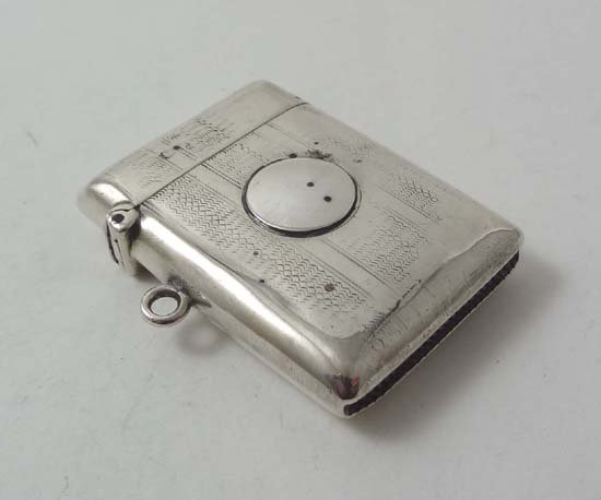 A HM silver vesta case with hinged lid and striker unde: A HM silver vesta case with hinged lid and striker under. Chester 1908 maker Martin Hall & Co (28g)