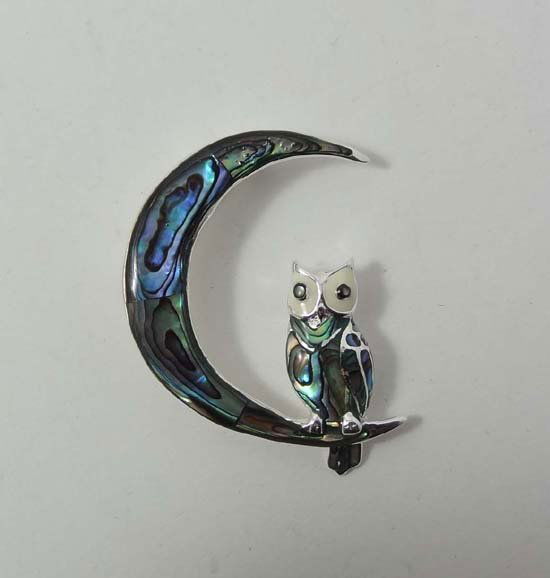 A silver brooch formed as an owl and moon set with paua: A silver brooch formed as an owl and moon set with paua / abalone shell 2" highb