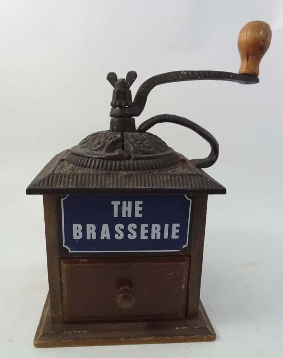A French cast iron and wooden coffee grinder marked wit: A French cast iron and wooden coffee grinder marked with enamel plaque ;' The Brassiere ' Approx 10" high