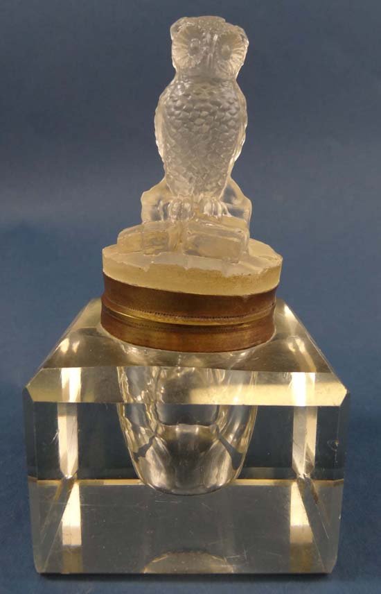 A glass inkwell with silver plate hinged top surmounted: A glass inkwell with silver plate hinged top surmounted by cast figure of an owl 5 14" high