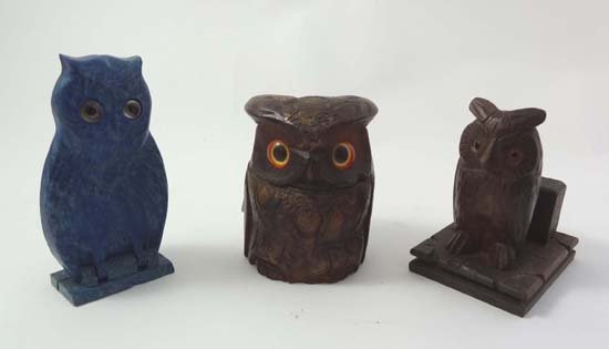 A carved wooden owl formed hinged lidded inkwell, Black: A carved wooden owl formed hinged lidded inkwell, Black Forest matchcase and a Bourgois blue Bakelite perfume case in the form of an owl.
