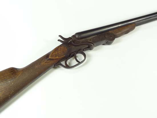 A Belgian double barrelled folding hammer .410 shotgun : A Belgian double barrelled folding hammer .410 shotgun , with side opening lever and fully folding push button, bears Liege proof marks, game stock, barrels marked 10.& 10.4, barrels 27 1/16" long, no