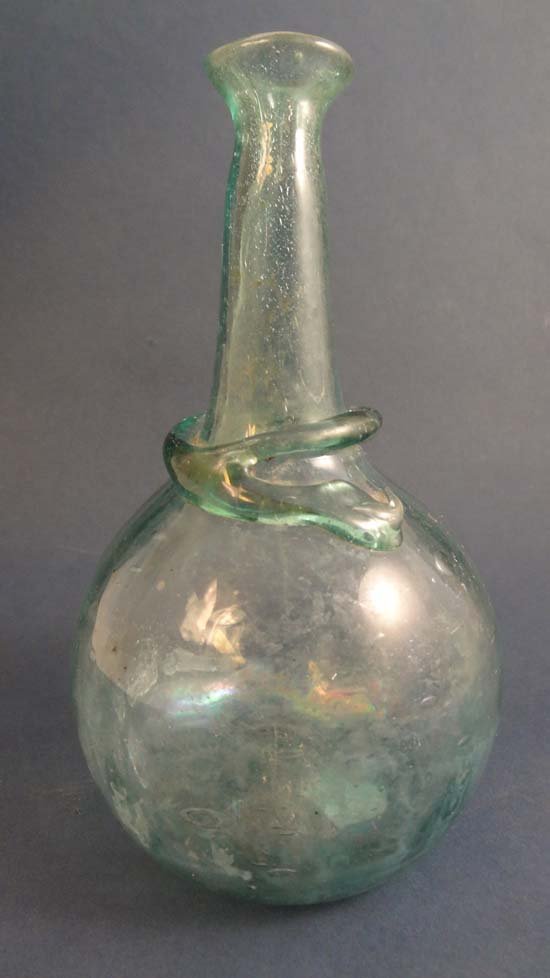 A Roman style glass bottle with traces of iridescence a: A Roman style glass bottle with traces of iridescence and ringed collar. As found on the Isle of Wight approx 5 3/4" high