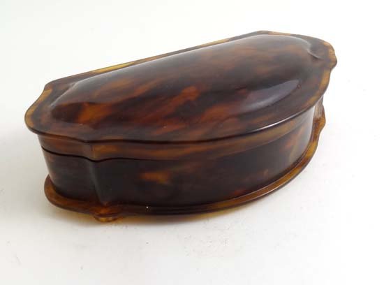 A 1930's faux tortoiseshell bowfront silk lined jewelle: A 1930's faux tortoiseshell bowfront silk lined jewellery box 5 3/4" wide