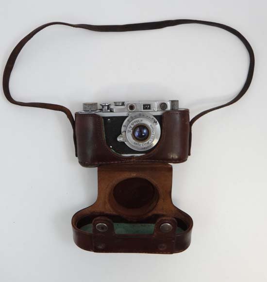 A copy of a Leica signed camera with leather: A copy of a Leica signed camera with leather case and Leitz Elmar lens stamped to top with Nazi eagle and Swastiker.