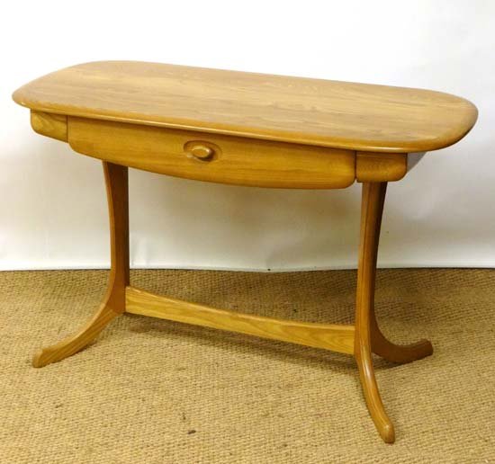 Vintage Retro : Ercol style blonde Elm and Ash writing: Vintage Retro : Ercol style blonde Elm and Ash writing table with frieze drawer and flanked by two pen drawers on a four feet united by a single stretcher. 21" wide and 44 long