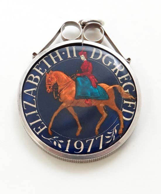 An Elizabeth II DG.REG FD 1977 enamelled crown in a sil: An Elizabeth II DG.REG FD 1977 enamelled crown in a silver mount 1 1/2" wide