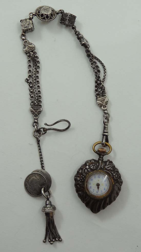 An unusual silver plate heart shaped pendant top wind c