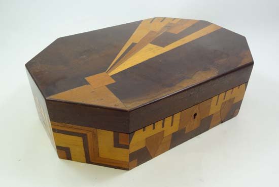An Art Deco parquetry jewellery box of rectangular shap: An Art Deco parquetry jewellery box of rectangular shape with canted corners, decorated with geometric design of the genre, the cover lifting to reveal fitted lift-out tray with further storage beneat