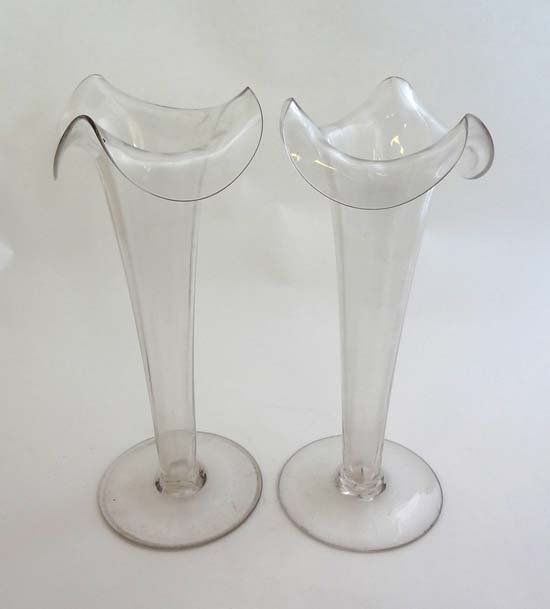 A pair of 19thC clear glass pedestal epergnes with wavy: A pair of 19thC clear glass pedestal epergnes with wavy rim decoration 11" high