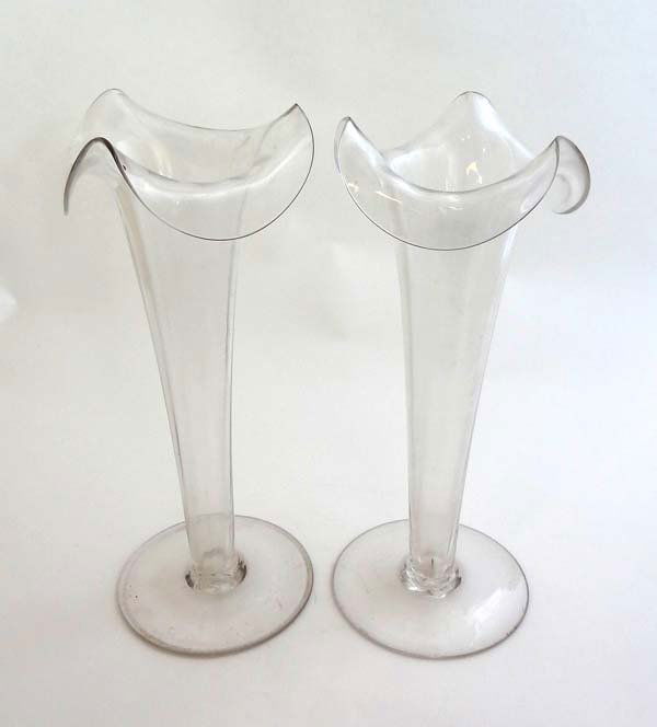 A pair of 19thC clear glass pedestal epergnes with wavy: A pair of 19thC clear glass pedestal epergnes with wavy rim decoration 11" high